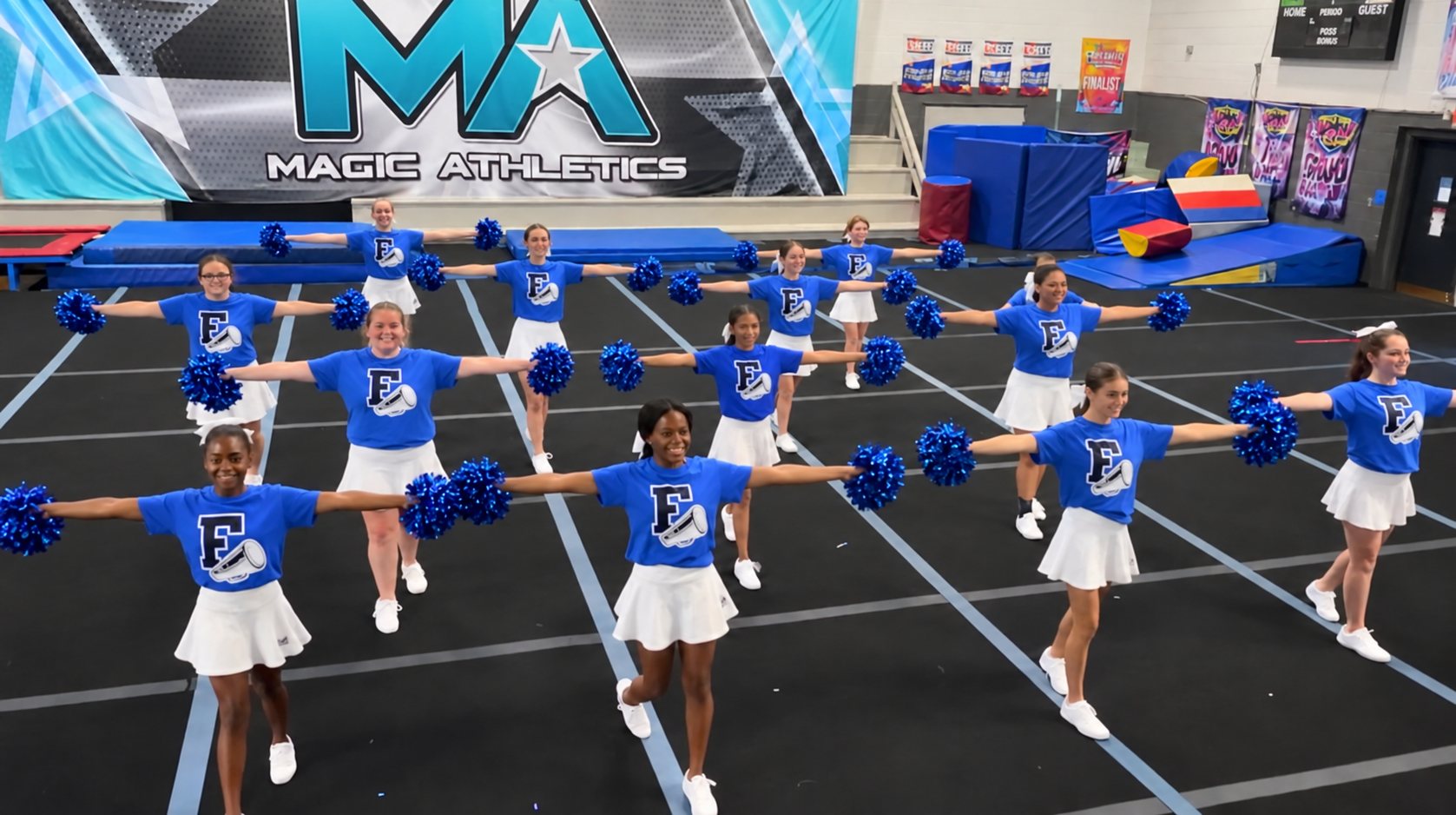 School cheerleaders practicing a pom routine at Magic Athletics